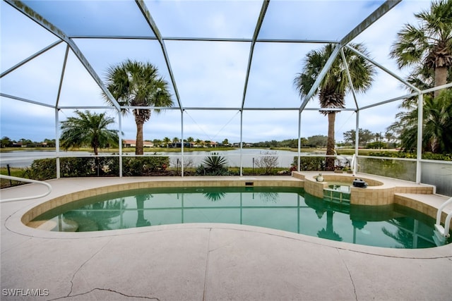 view of pool featuring a pool with connected hot tub, glass enclosure, and a water view