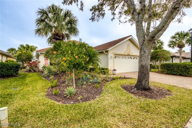 view of front of property featuring an attached garage, stucco siding, decorative driveway, and a front yard