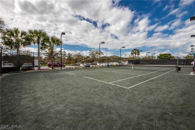 view of sport court featuring fence