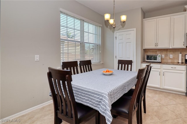 tiled dining space featuring a notable chandelier