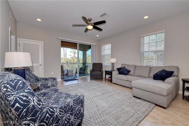 living room featuring plenty of natural light, ceiling fan, and light tile patterned flooring