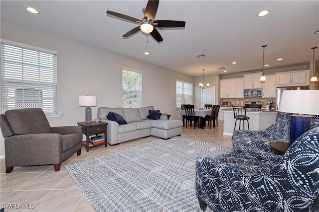 tiled living room featuring ceiling fan