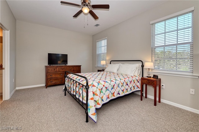 bedroom featuring light colored carpet and ceiling fan