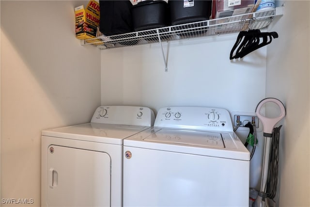 clothes washing area with separate washer and dryer