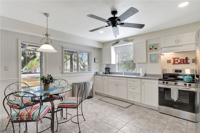 kitchen featuring white cabinetry, stainless steel electric stove, and a healthy amount of sunlight