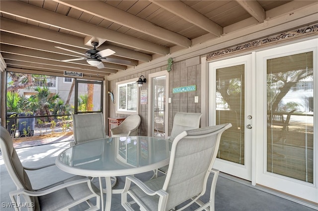 sunroom / solarium with beam ceiling, wooden ceiling, and ceiling fan