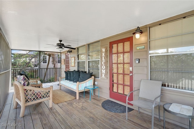 sunroom featuring ceiling fan