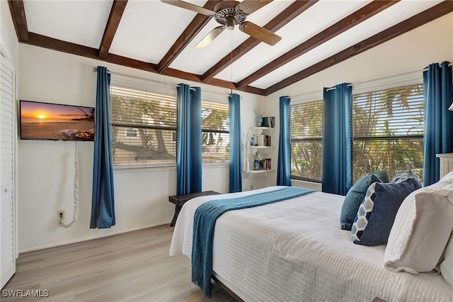 bedroom featuring ceiling fan, vaulted ceiling with beams, and light hardwood / wood-style floors