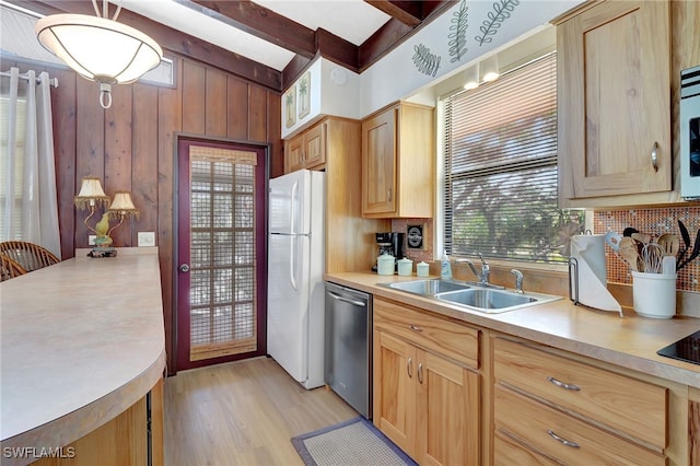 kitchen featuring wooden walls, beamed ceiling, dishwasher, sink, and white fridge