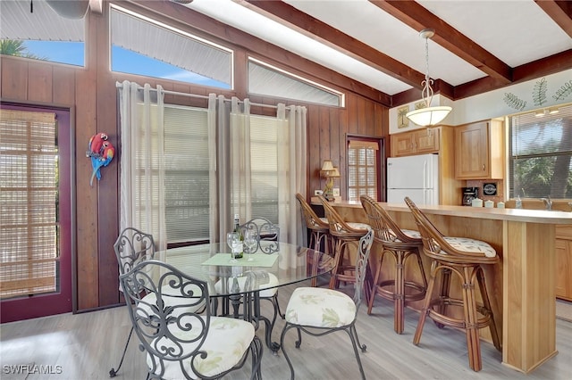 5370/5372 Palmetto St, Fort Myers Beach, FL 33931 - dining space with lofted ceiling with beams, light wood-style flooring, and wooden walls