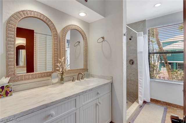 bathroom featuring vanity, a wealth of natural light, and walk in shower