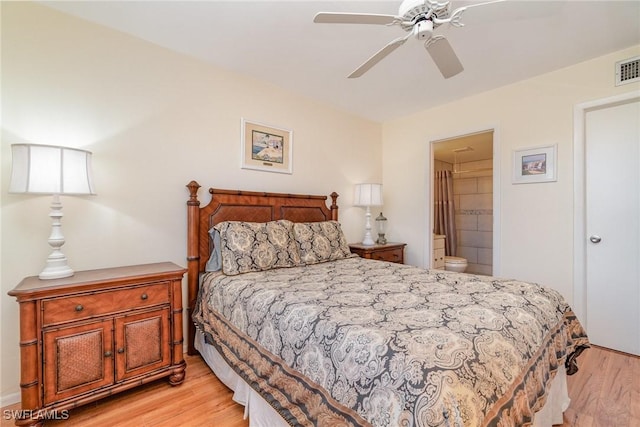 bedroom featuring ceiling fan, ensuite bath, and light hardwood / wood-style flooring