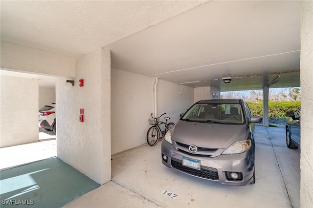 garage featuring a carport and a garage door opener