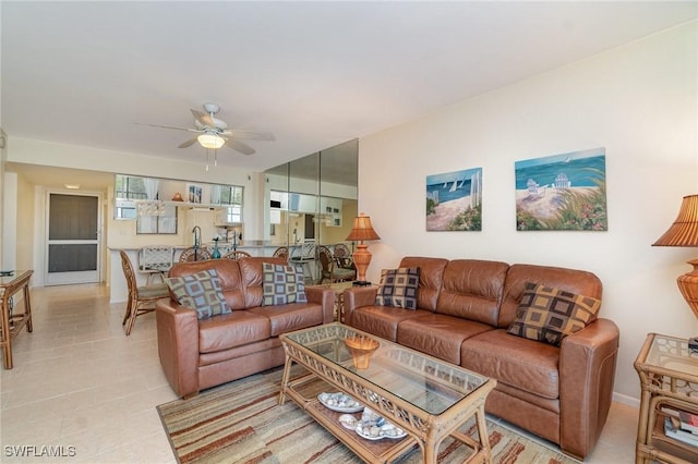 tiled living room featuring ceiling fan