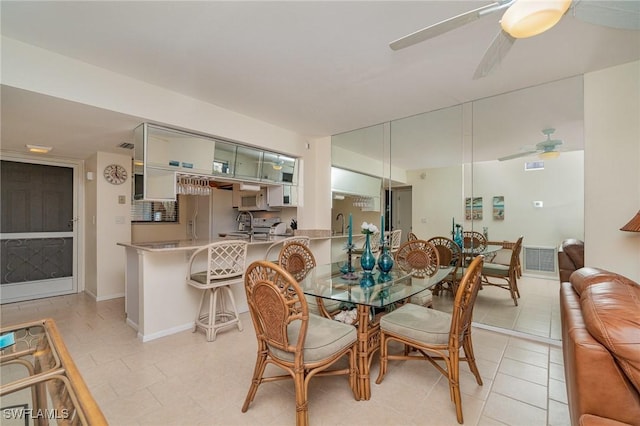 dining room with light tile patterned flooring and ceiling fan