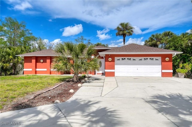 ranch-style house with a garage, concrete driveway, a front lawn, and stucco siding