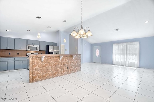 kitchen with light tile patterned floors, gray cabinets, backsplash, appliances with stainless steel finishes, and open floor plan