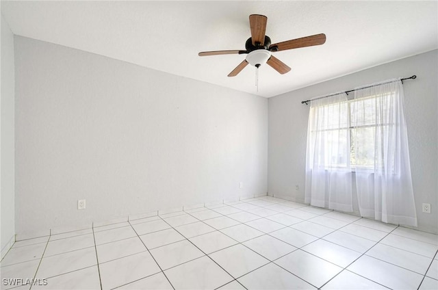 unfurnished room featuring ceiling fan and light tile patterned flooring