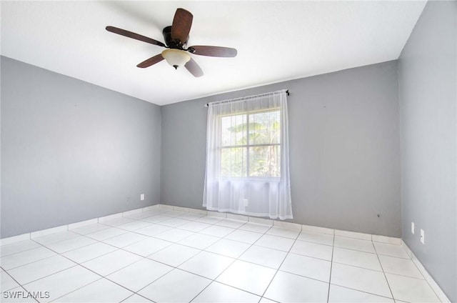 empty room with a ceiling fan and light tile patterned floors