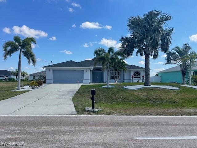 single story home featuring a garage and a front lawn