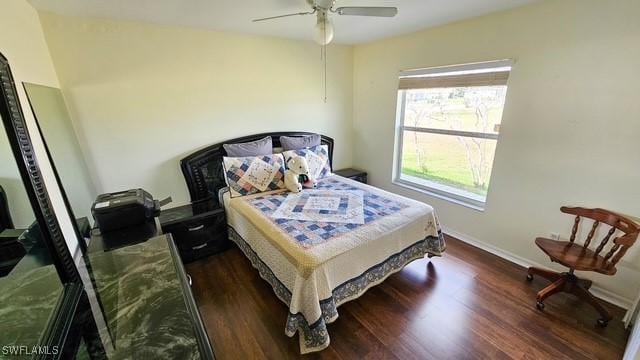 bedroom with ceiling fan, wood finished floors, and baseboards