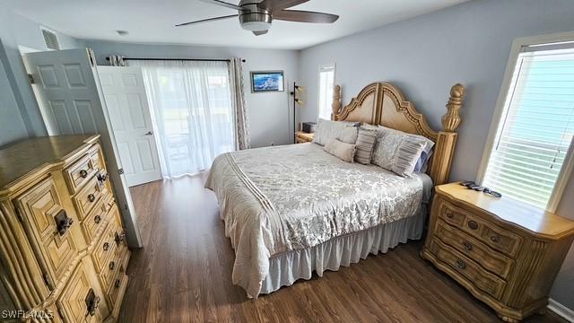 bedroom with dark wood-type flooring, visible vents, and ceiling fan