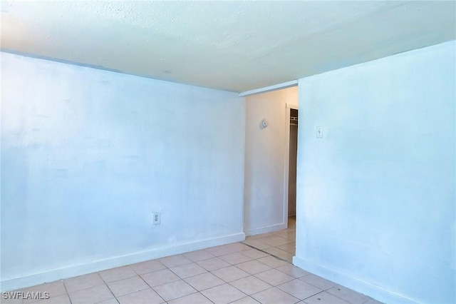 spare room featuring light tile patterned floors