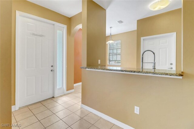 entrance foyer with sink and light tile patterned floors