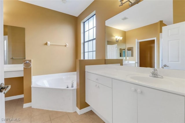 bathroom with visible vents, baseboards, a bath, tile patterned floors, and vanity