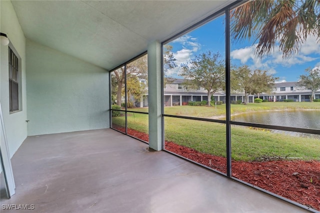 unfurnished sunroom with a water view