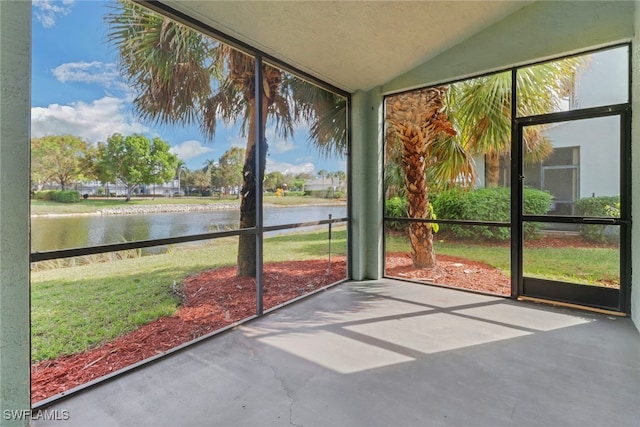 unfurnished sunroom with a water view and lofted ceiling