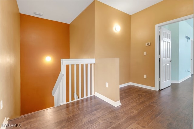 unfurnished room with dark wood-type flooring