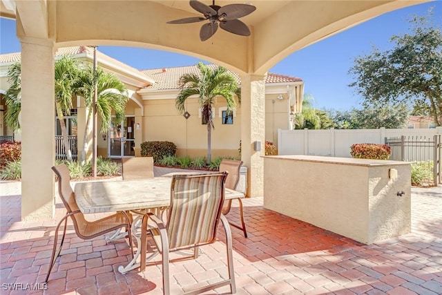 view of patio / terrace with ceiling fan and exterior bar