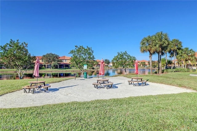 view of play area with a water view and a yard