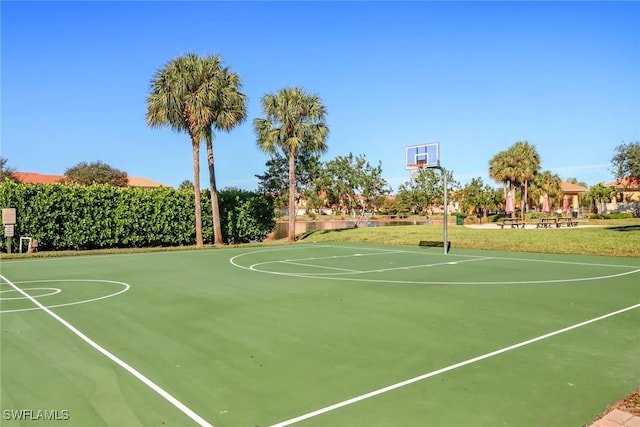 view of sport court featuring a yard