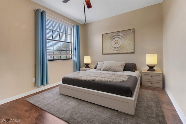 bedroom featuring wood finished floors, baseboards, and ceiling fan