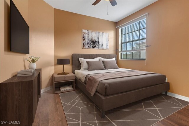 bedroom with dark wood-type flooring and ceiling fan