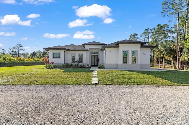 prairie-style home featuring a front lawn