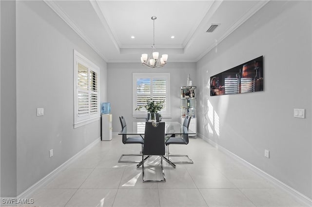 dining area featuring a notable chandelier, a tray ceiling, ornamental molding, and light tile patterned floors