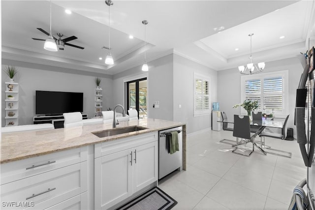 kitchen with white cabinetry, dishwasher, sink, and a raised ceiling