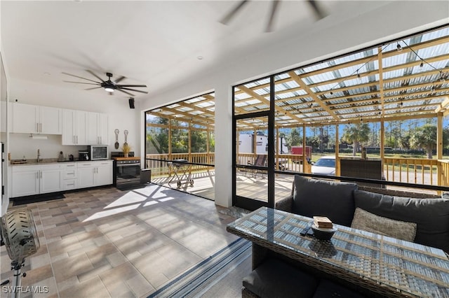 sunroom / solarium with ceiling fan