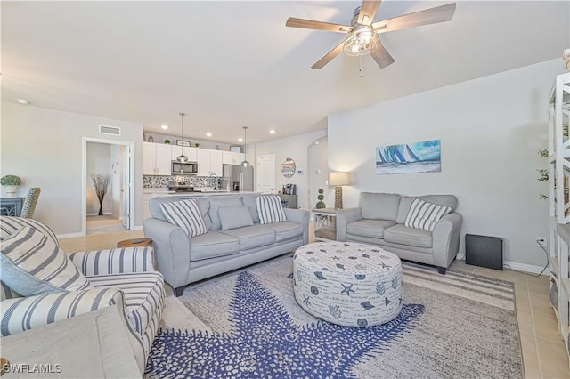 living room featuring ceiling fan and light tile patterned floors