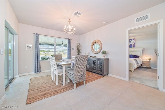 dining area featuring an inviting chandelier and light tile patterned floors