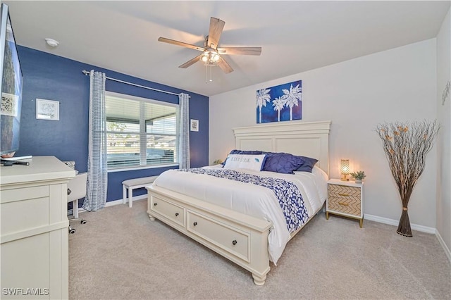 bedroom with ceiling fan and light carpet