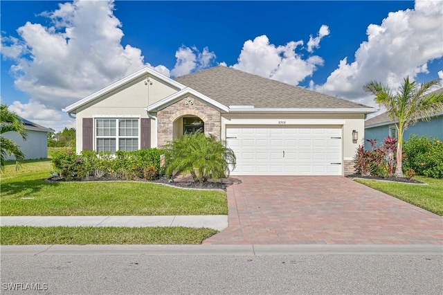 single story home featuring a garage and a front yard