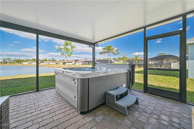 8908 Cascade Price Cir, North Fort Myers, FL 33917 - sunroom featuring a residential view, a wealth of natural light, a hot tub, and a water view