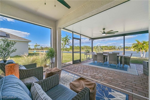 sunroom featuring a healthy amount of sunlight and ceiling fan