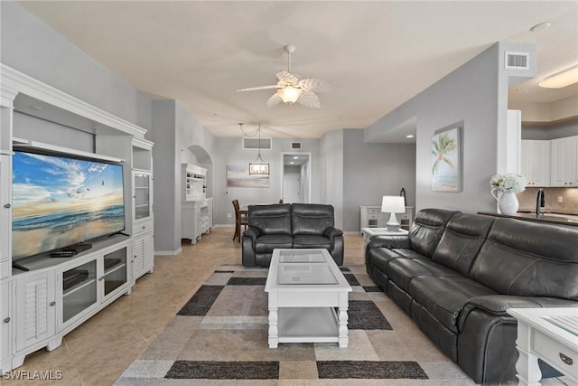 tiled living room with ceiling fan