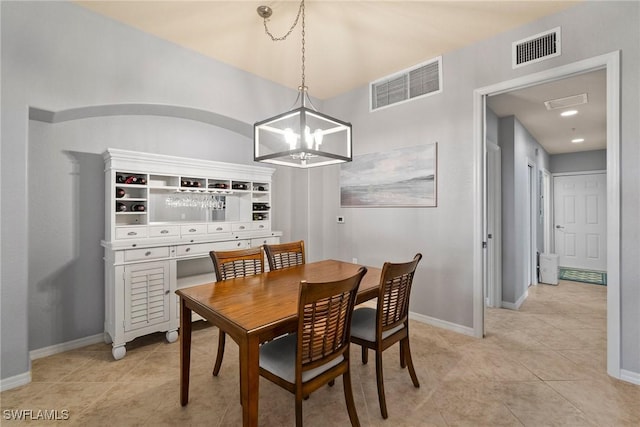 dining area featuring an inviting chandelier and light tile patterned floors