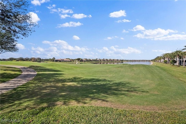 surrounding community with a lawn and a water view